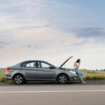 A,Frustrated,Young,Girl,Stands,Near,A,Broken-down,Car,In