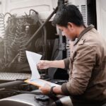 Truck,Driver,Is,Checking,The,Truck's,Safety,Maintenance,Checklist.,Mechanic